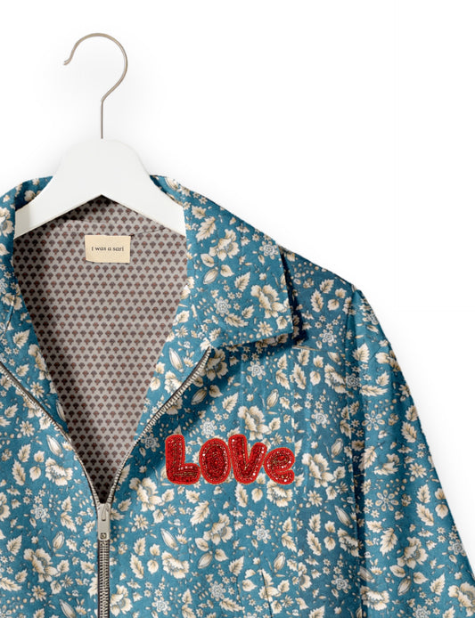 Love Bomber Jacket made from recycled fabric, featuring hand-stitched Aari embroidery. A unique piece of zero-waste clothing, part of the circular fashion movement. Designed with upcycled materials for a stylish yet environmentally friendly clothing choice.