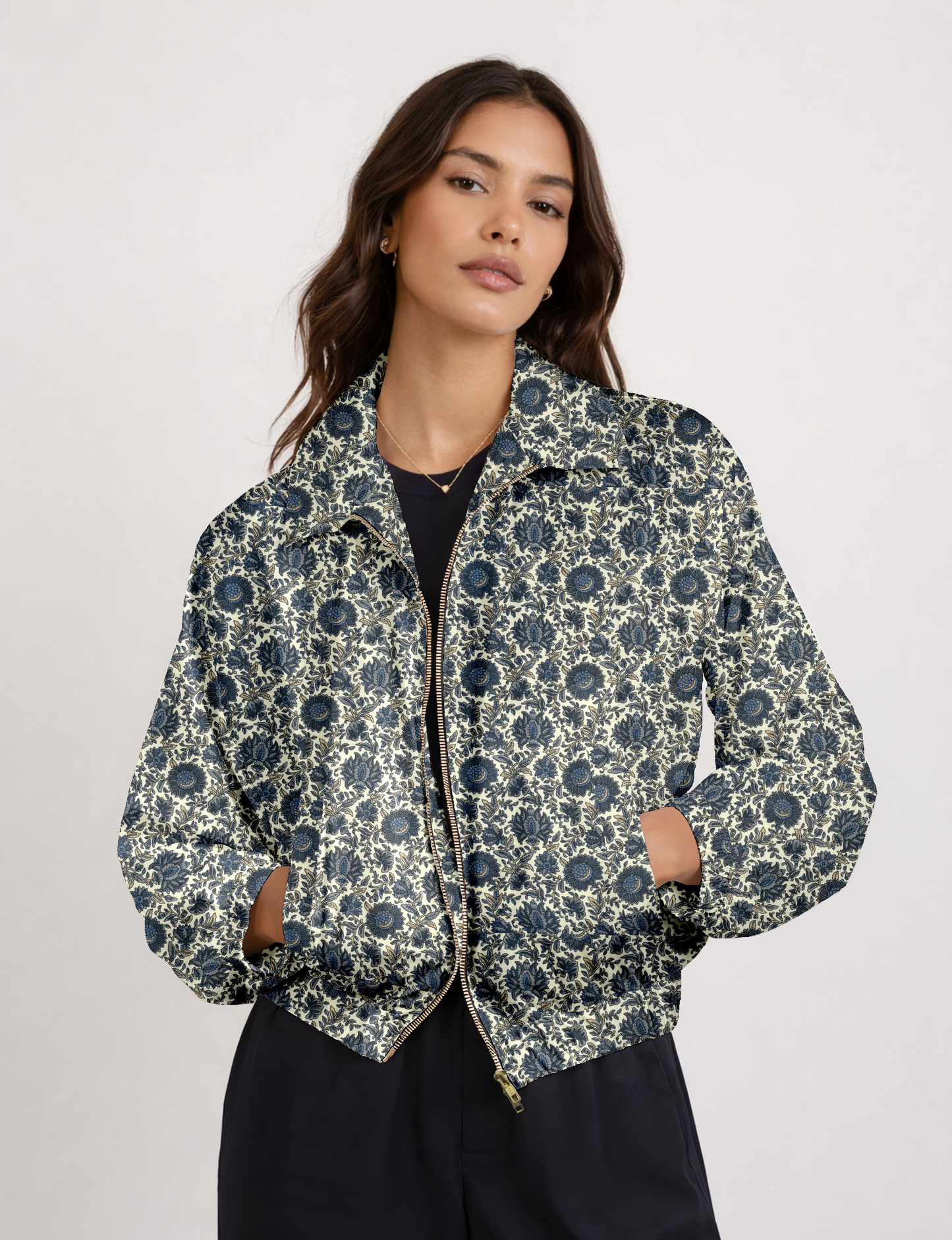 Women's cropped bomber jacket with twin metallic front zippers, welt pockets, elasticated hem and cuffs, and contrast sari print lining.