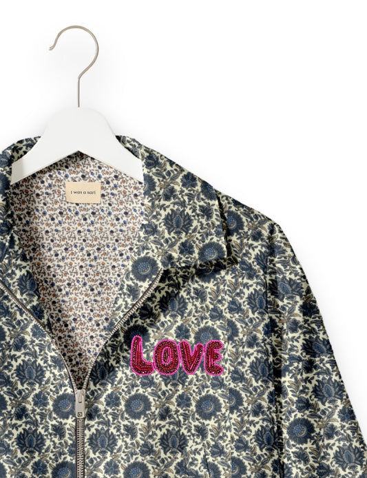 Love Bomber Jacket made from recycled fabric, featuring hand-stitched Aari embroidery. A unique piece of zero-waste clothing, part of the circular fashion movement. Designed with upcycled materials for a stylish yet environmentally friendly clothing choice.