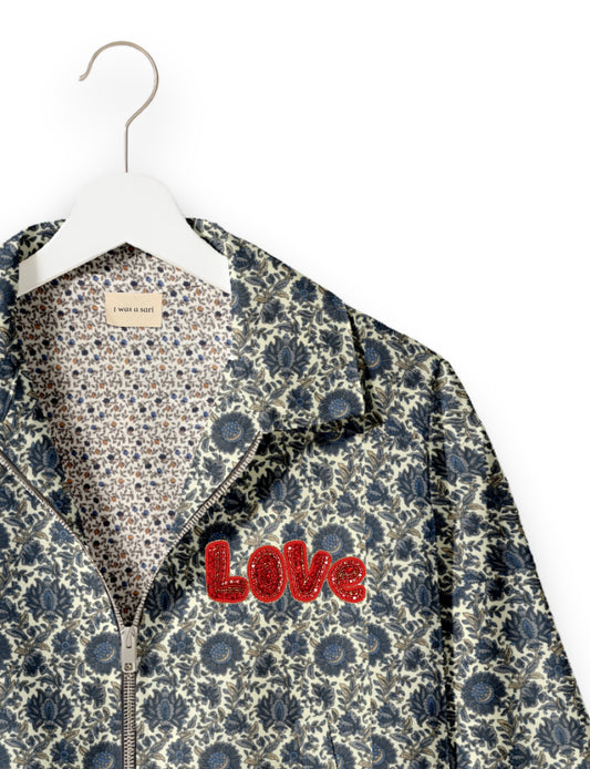 Love Bomber Jacket made from recycled fabric, featuring hand-stitched Aari embroidery. A unique piece of zero-waste clothing, part of the circular fashion movement. Designed with upcycled materials for a stylish yet environmentally friendly clothing choice.