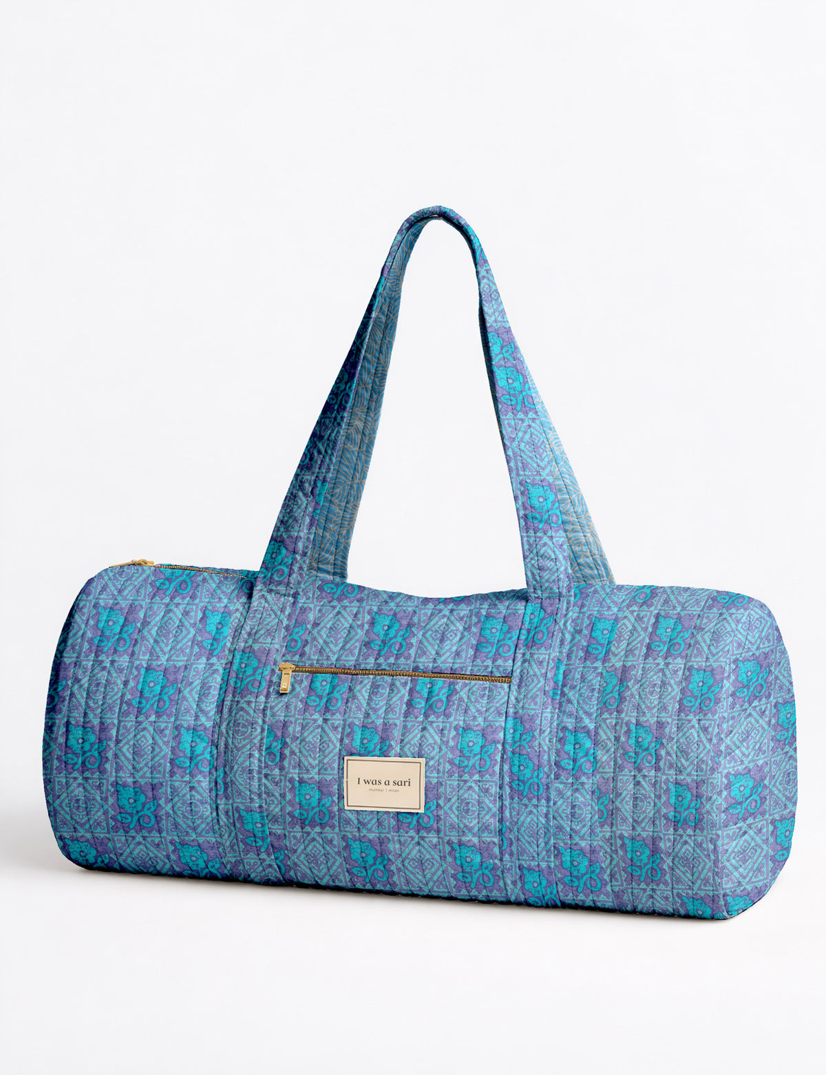 Brown paisley quilted bowling bag with dual handles, front zipper pocket, and "I was a sari" label on front side