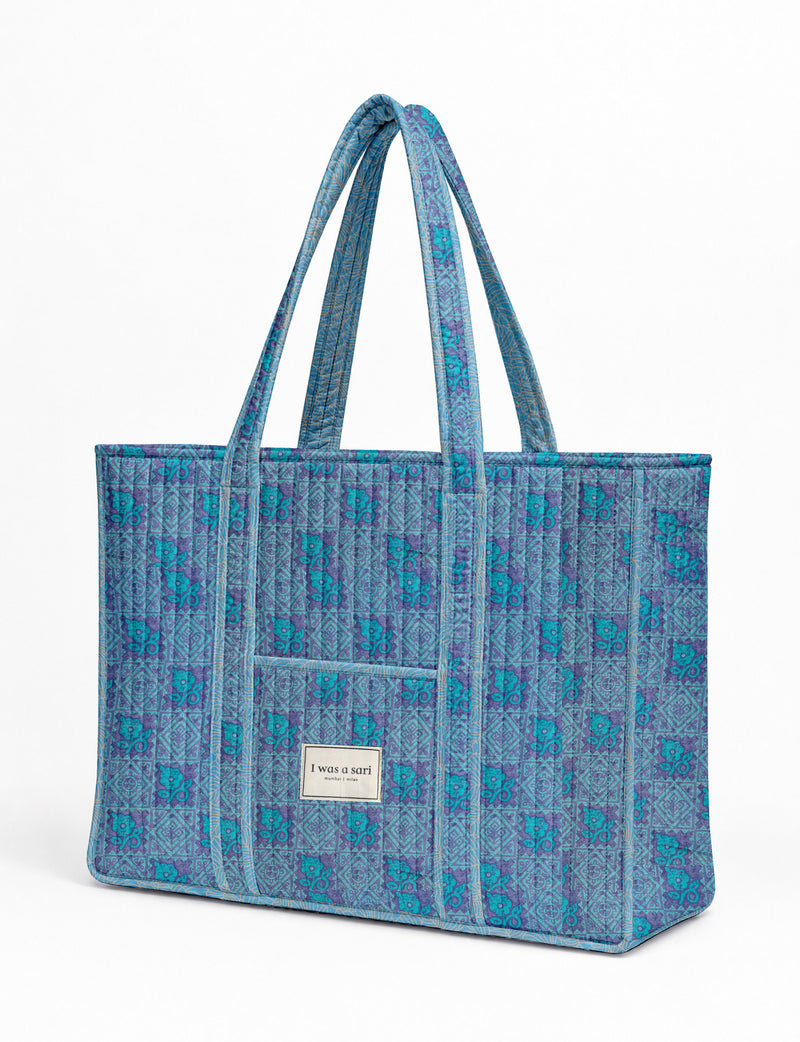 Quilted work tote bag with structured rectangular design and long shoulder straps, representing slow fashion and ethical clothing ideals, made as part of upcycled women's clothing and sustainable women's clothing using recycled fashion and earth friendly clothing practices.