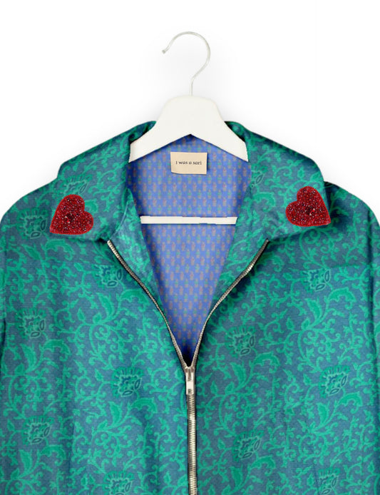 Make a bold statement with our Heart Drop Earrings, a symbol of conscious luxury and ethical fashion. Handcrafted using the intricate Aari embroidery technique, these earrings are made from upcycled sari fabric, embracing slow fashion and zero waste clothing. Elevate your look with sustainable apparel that supports fair trade fashion while reducing textile waste. Choose eco-friendly fashion that speaks of love, artistry, and responsibility.