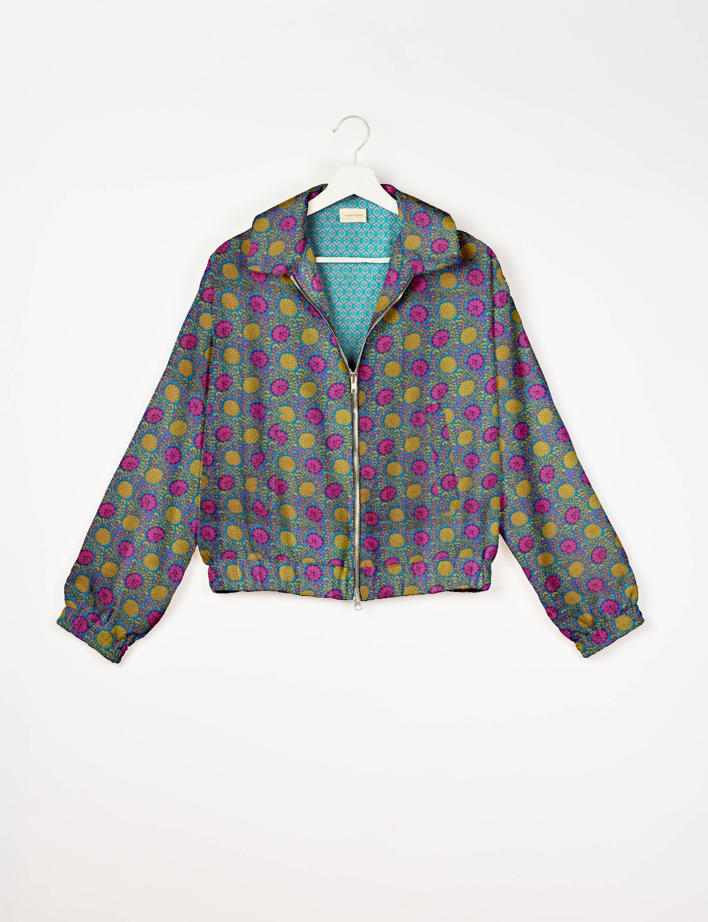 Upcycled Bomber Jacket made from recycled sari materials, featuring a cute cropped shape, elasticated hem and cuffs, and contrast sari print lining. Sustainable apparel promoting eco-friendly fashion and ethical clothing.