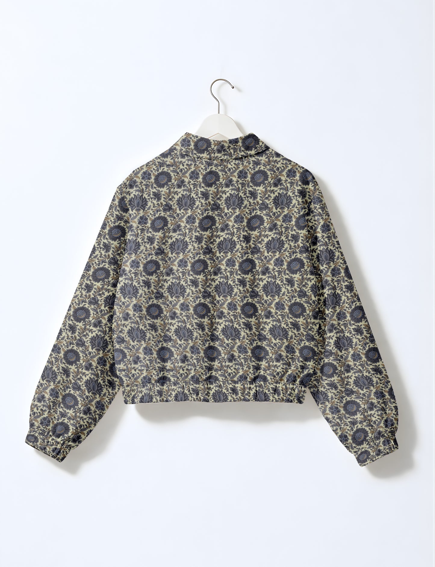 Yellow bomber jacket with micro diamond and floral pattern, elastic cuffs and waistband, shown from back on hanger