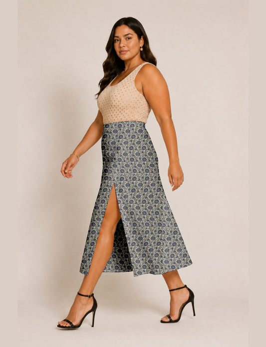 Woman wearing a yellow and black micro patterned A-line skirt with front slit, paired with beige sleeveless top and black