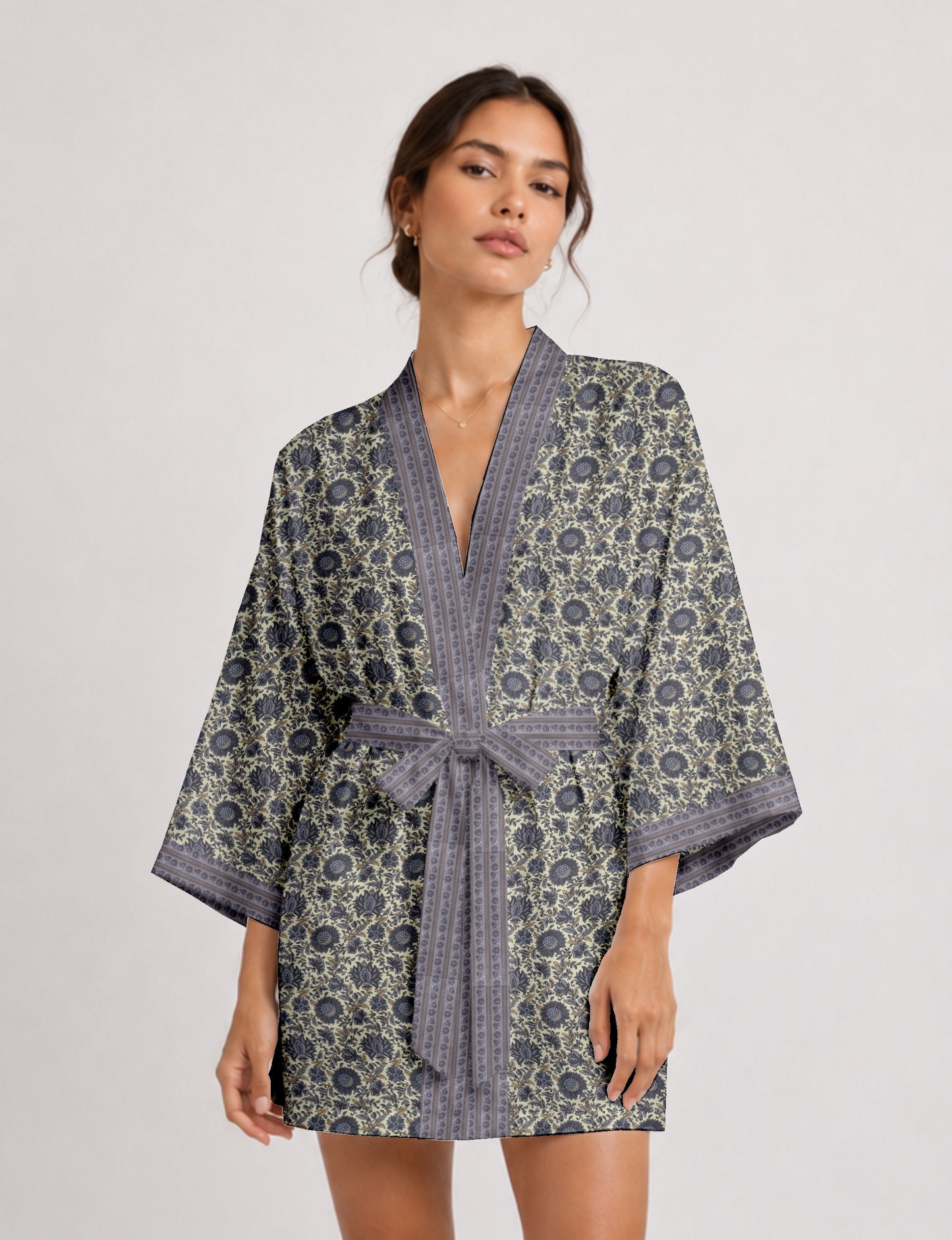 Short kimono robe with wrap front, V-neckline, wide sleeves, waist tie, and concealed skort detail.