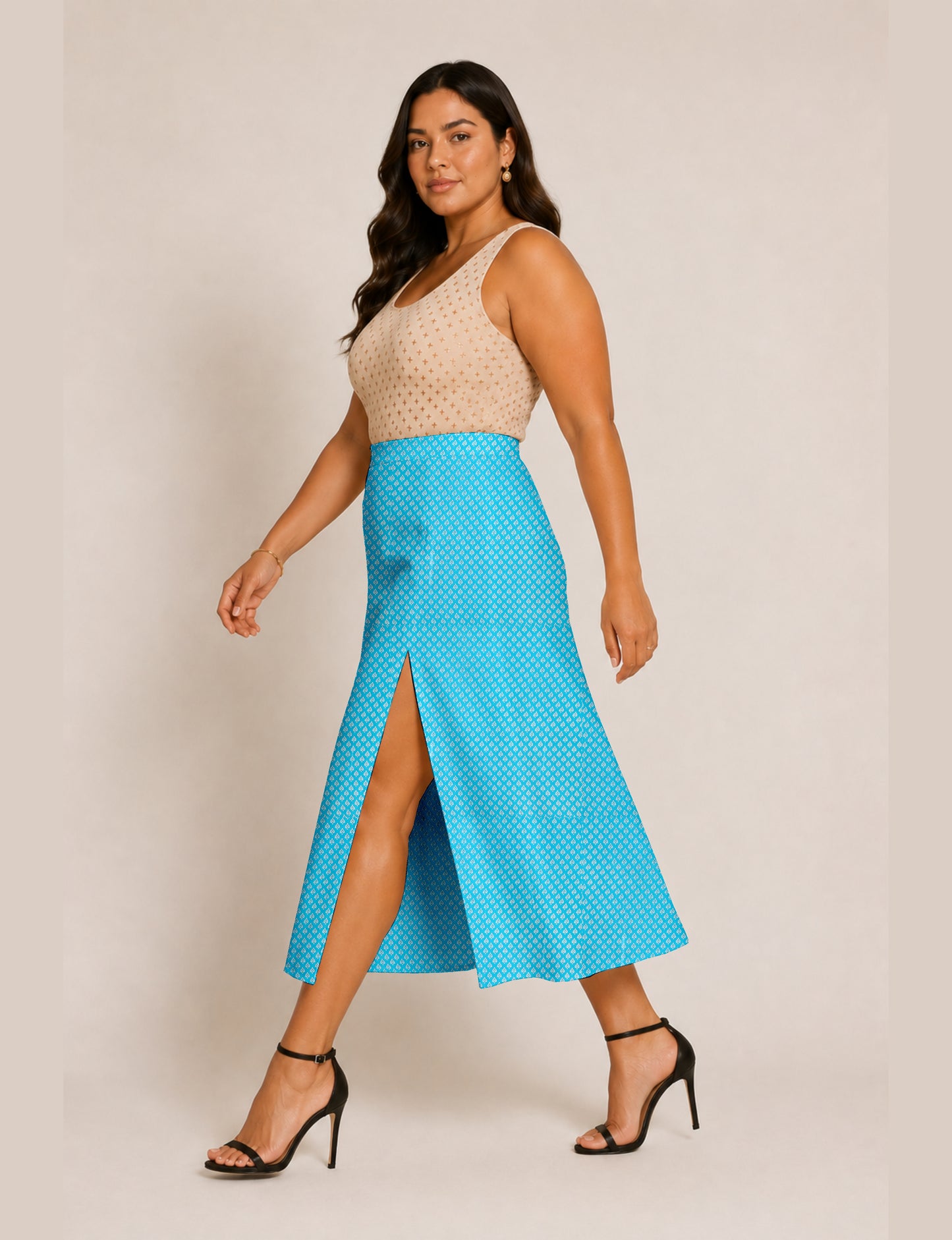 Woman wearing a yellow and black micro patterned A-line skirt with front slit, paired with beige sleeveless top and black