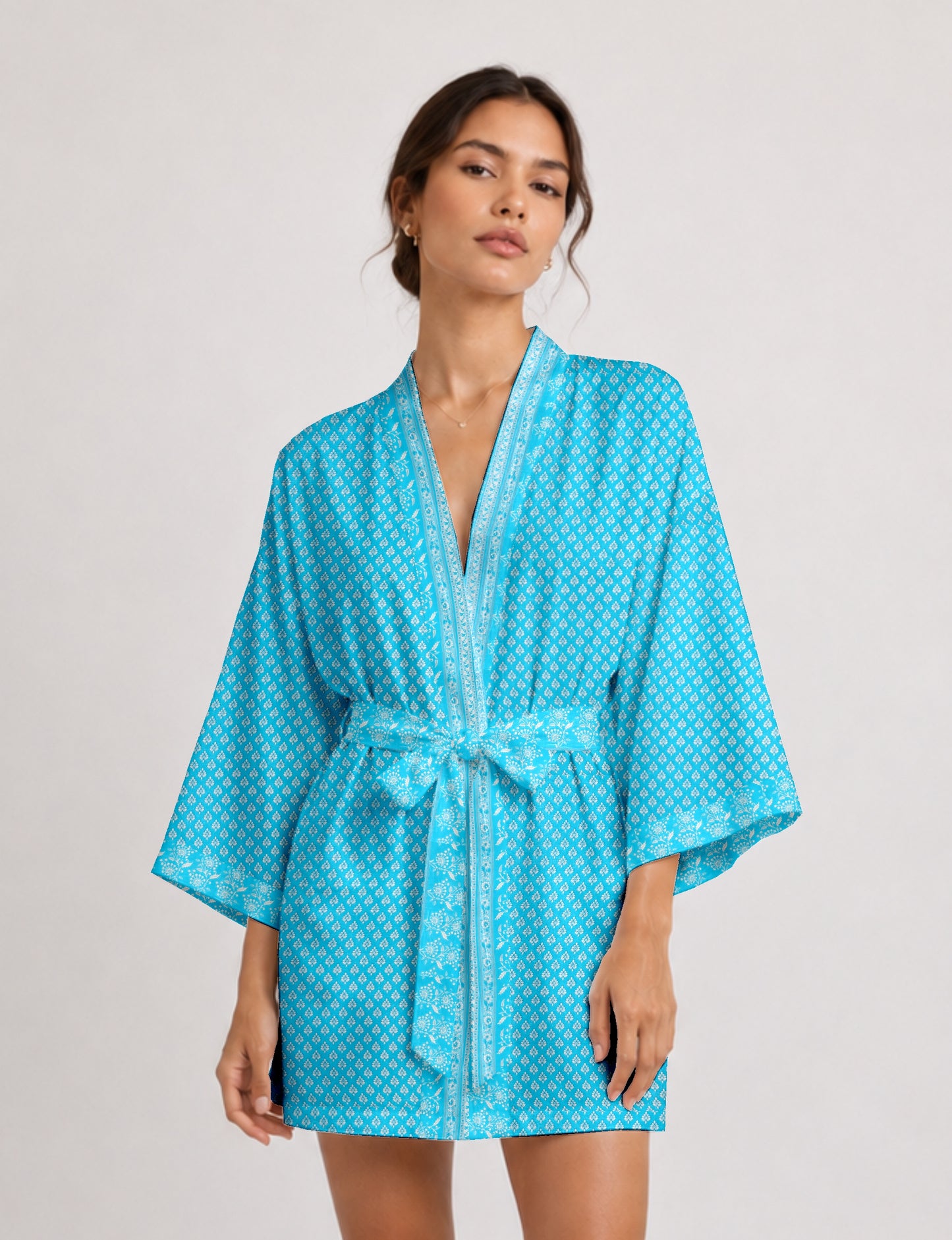 Short kimono robe with wrap front, V-neckline, wide sleeves, waist tie, and concealed skort detail.