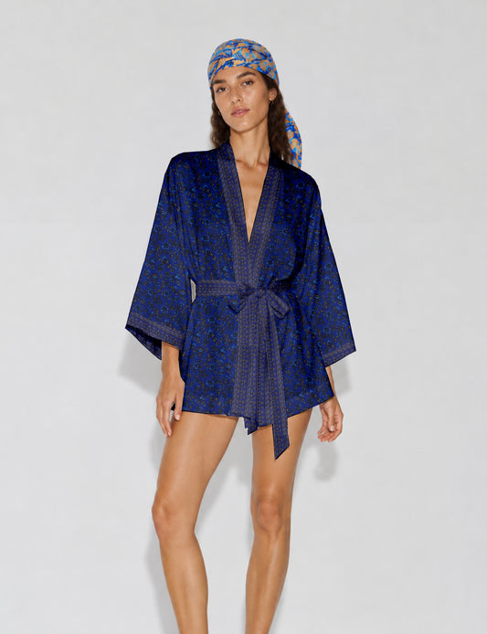 Short kimono robe with wrap front, V-neckline, wide sleeves, waist tie, and concealed skort detail.