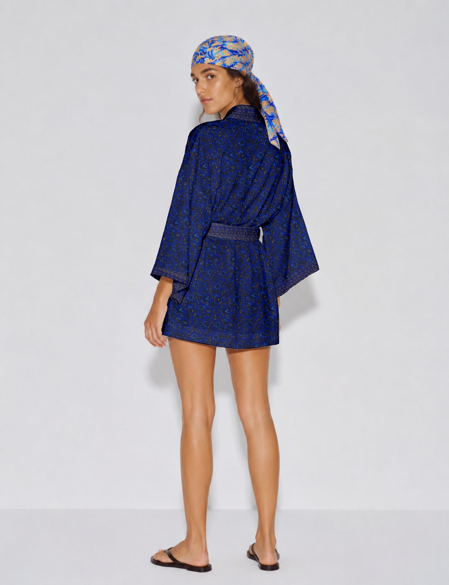 Short kimono robe with wrap front, V-neckline, wide sleeves, waist tie, and concealed skort detail.
