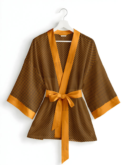 Short kimono robe with wrap front, V-neckline, wide sleeves, waist tie, and concealed skort detail.