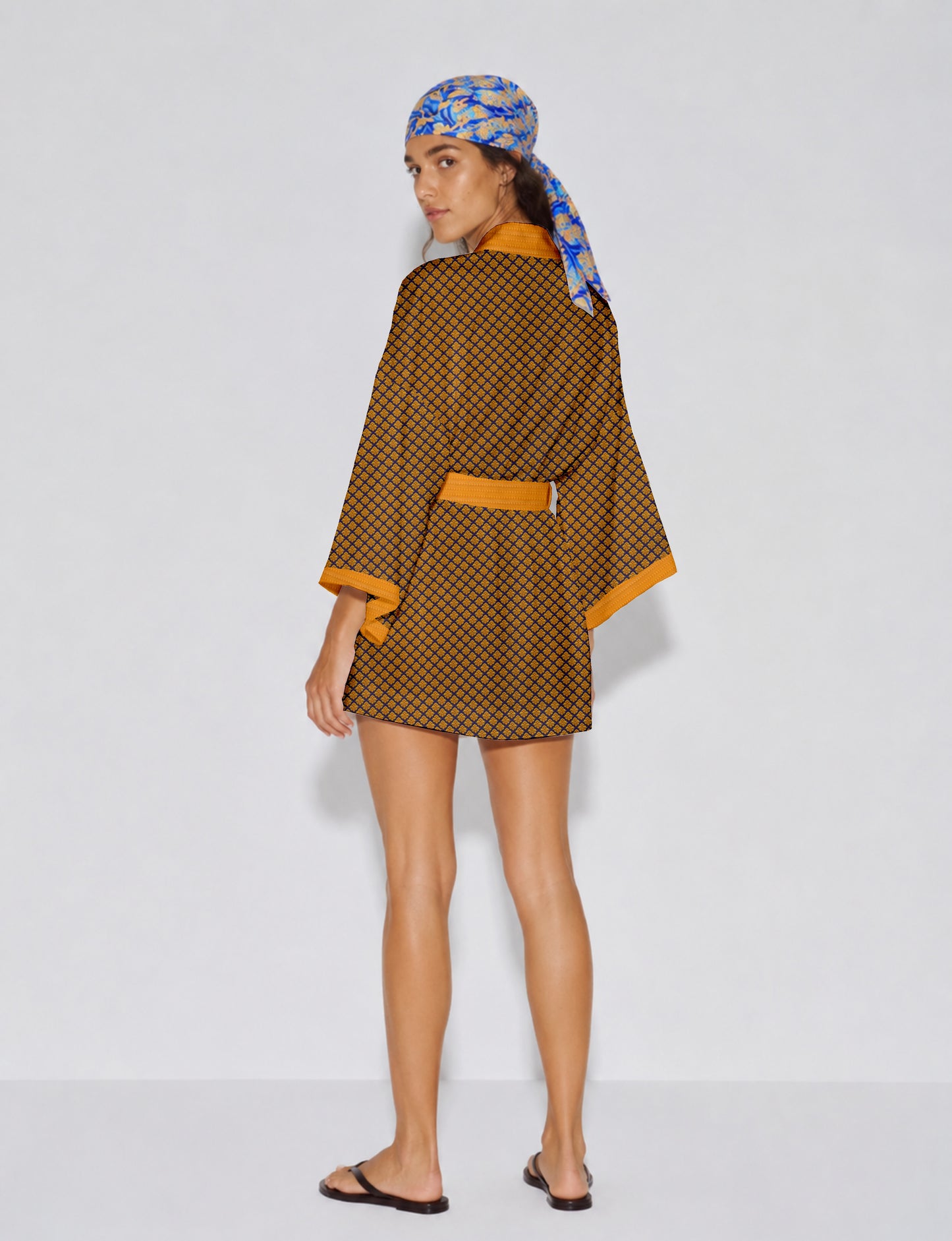 Short kimono robe with wrap front, V-neckline, wide sleeves, waist tie, and concealed skort detail.