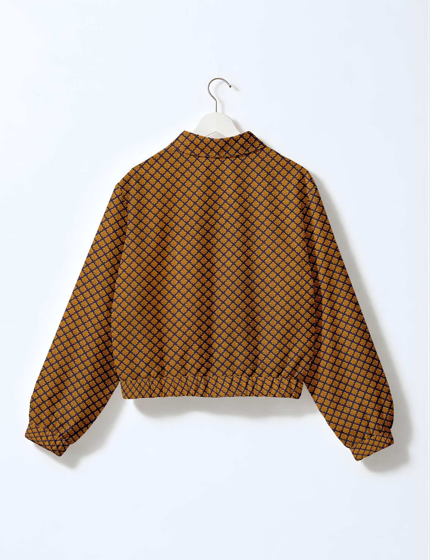 Yellow bomber jacket with micro diamond and floral pattern, elastic cuffs and waistband, shown from back on hanger