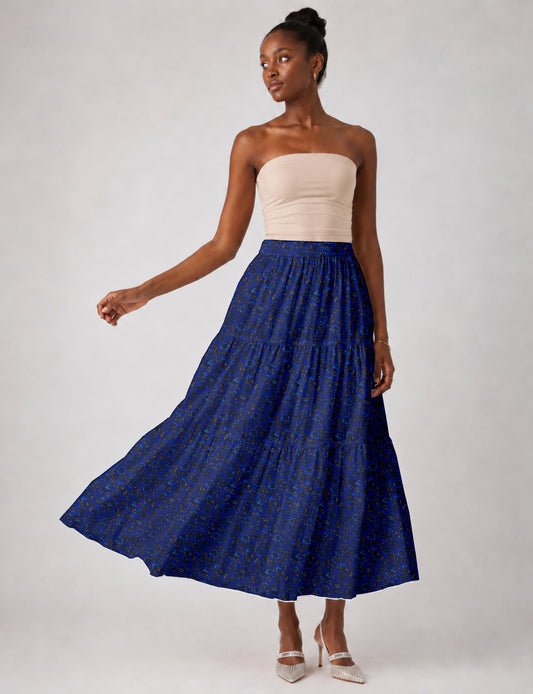 Midi tiered skirt with fitted waistband, soft knife pleats, flared silhouette, side seam pockets, and ankle-length hem