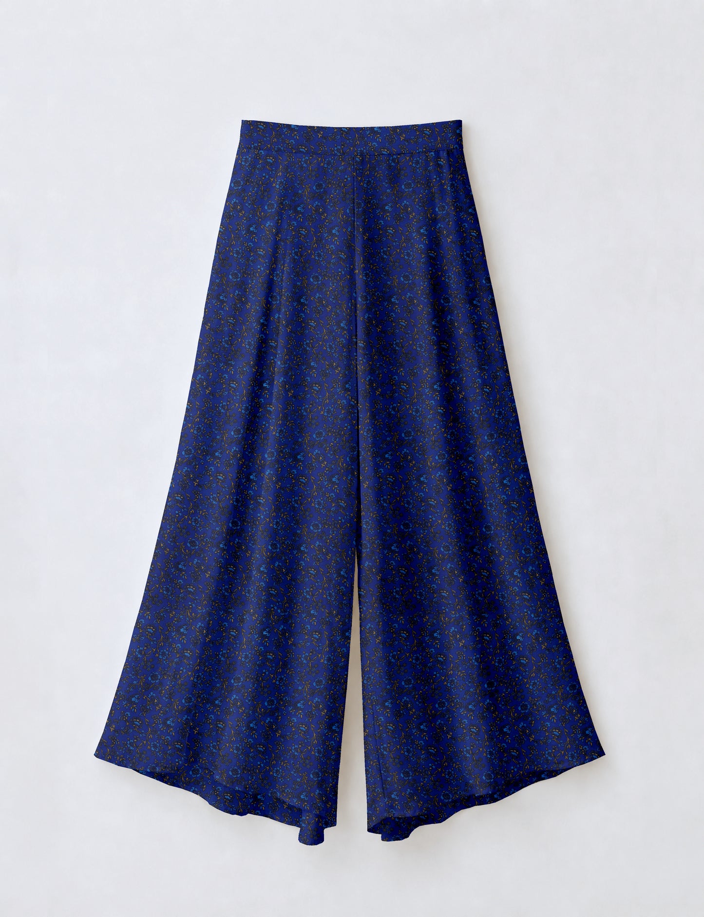 Blue wide leg palazzo trousers with a small tropical floral pattern, flat lay front view