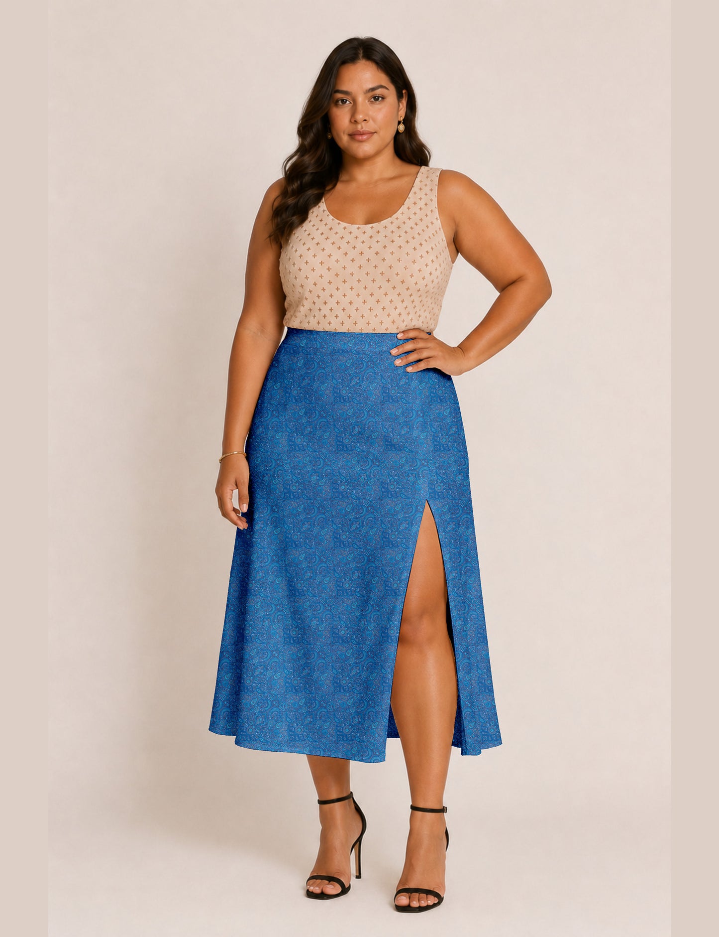 Woman wearing a yellow and black micro patterned A-line skirt with front slit, paired with beige sleeveless top and black