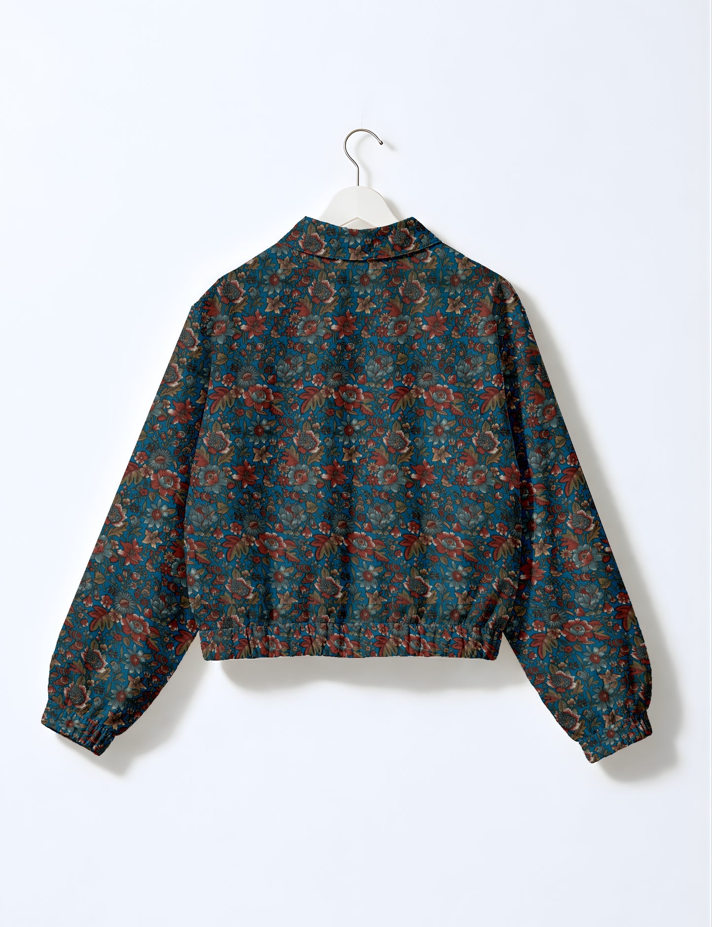 Women's cropped bomber jacket with twin metallic front zippers, welt pockets, elasticated hem and cuffs, and contrast sari print lining.