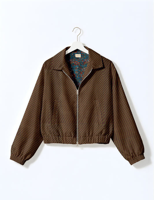 Women's cropped bomber jacket with twin metallic front zippers, welt pockets, elasticated hem and cuffs, and contrast sari print lining.