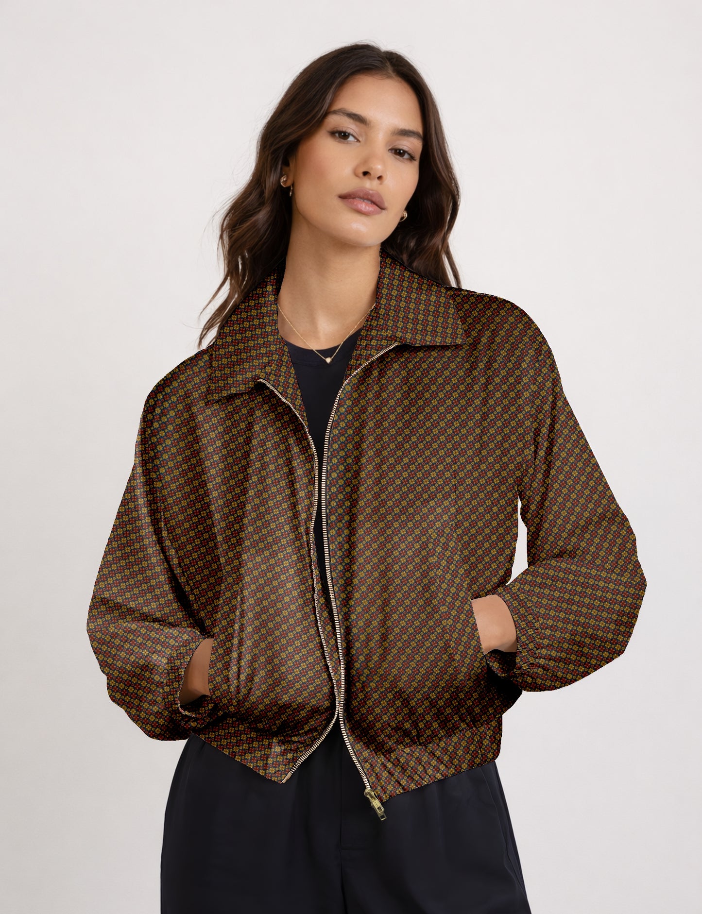Women's cropped bomber jacket with twin metallic front zippers, welt pockets, elasticated hem and cuffs, and contrast sari print lining.