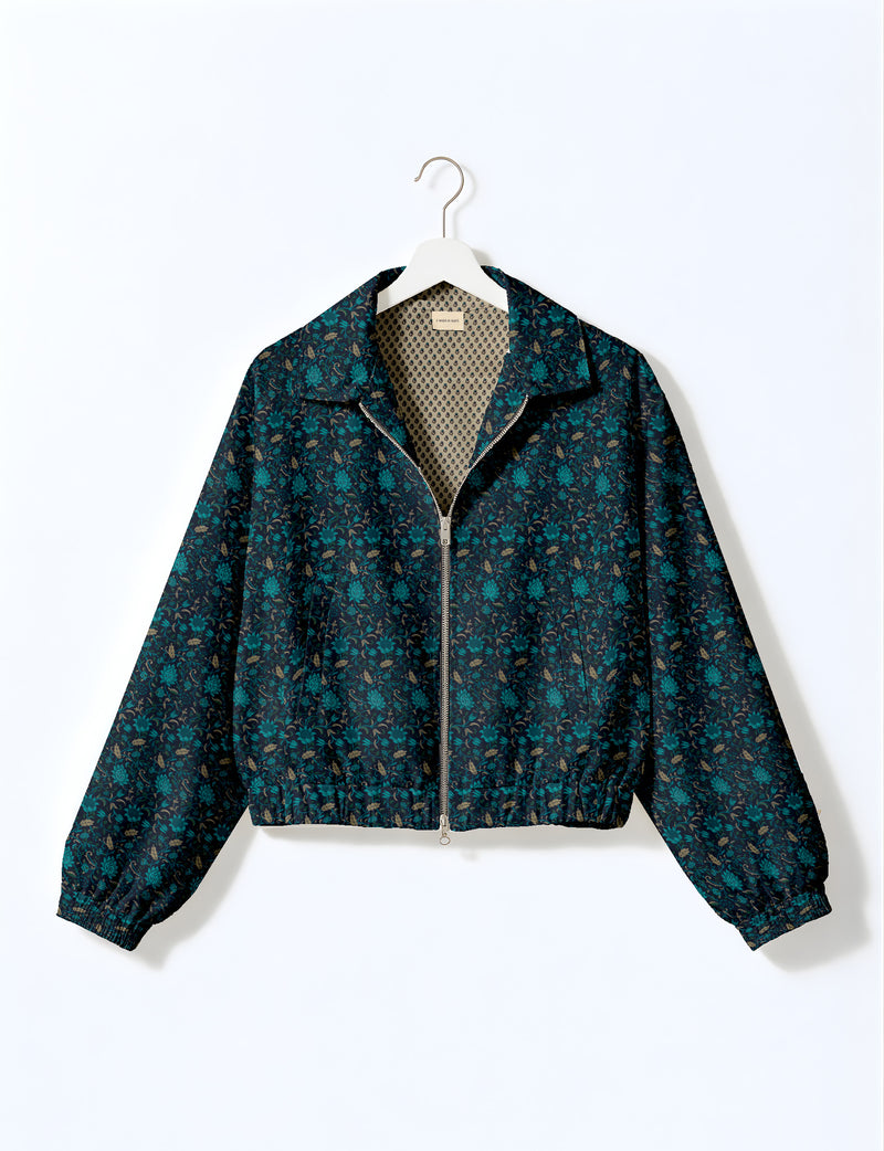 Brown floral bomber jacket with front zipper, elastic cuffs and hem, hanging on white hanger, red floral inner lining visible