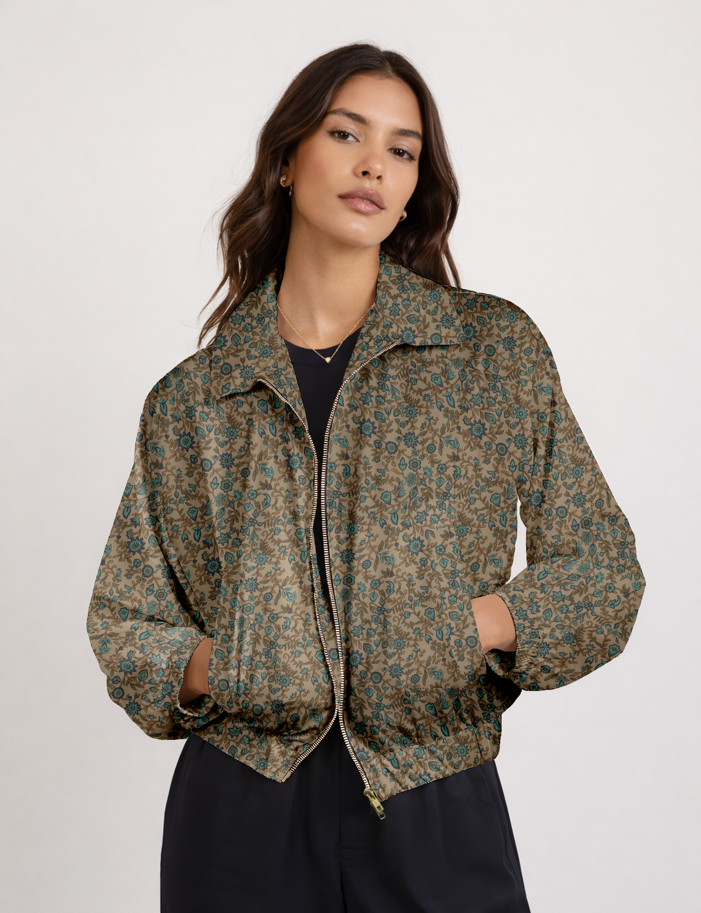 Women's cropped bomber jacket with twin metallic front zippers, welt pockets, elasticated hem and cuffs, and contrast sari print lining.