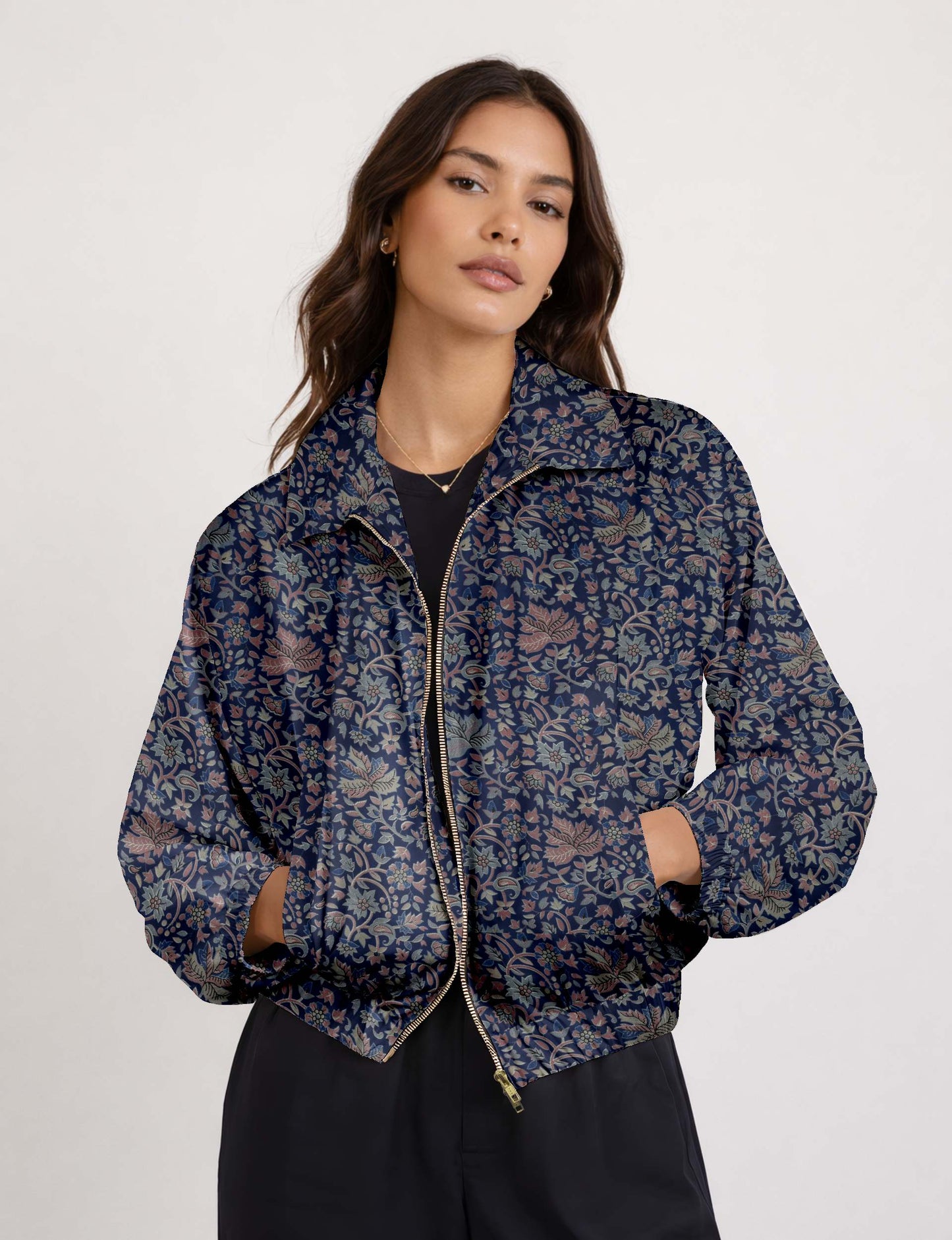 Brown floral bomber jacket with front zipper, elastic cuffs and hem, hanging on white hanger, red floral inner lining visible