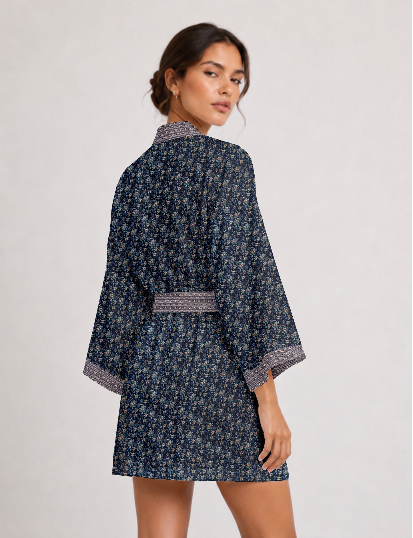 Short kimono robe with wrap front, V-neckline, wide sleeves, waist tie, and concealed skort detail.