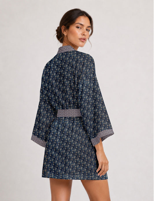 Short kimono robe with wrap front, V-neckline, wide sleeves, waist tie, and concealed skort detail.