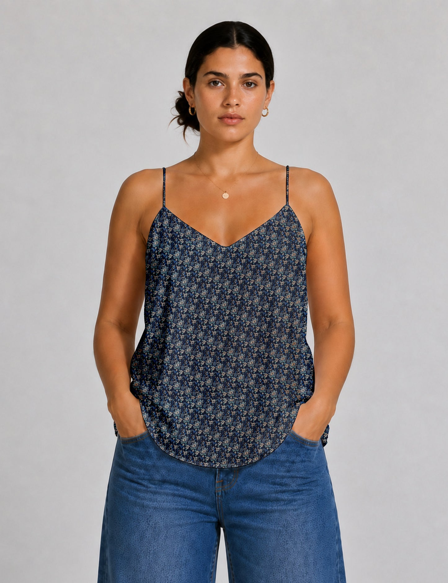 Women's sleeveless slip top with a relaxed straight fit, soft V-neckline, deep V-back, and delicate spaghetti straps.