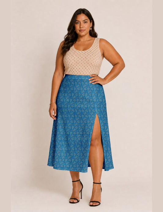 Woman wearing a yellow and black micro patterned A-line skirt with front slit, paired with beige sleeveless top and black