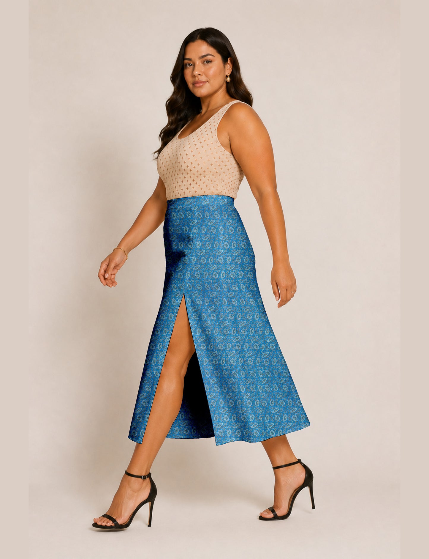 Woman wearing a yellow and black micro patterned A-line skirt with front slit, paired with beige sleeveless top and black
