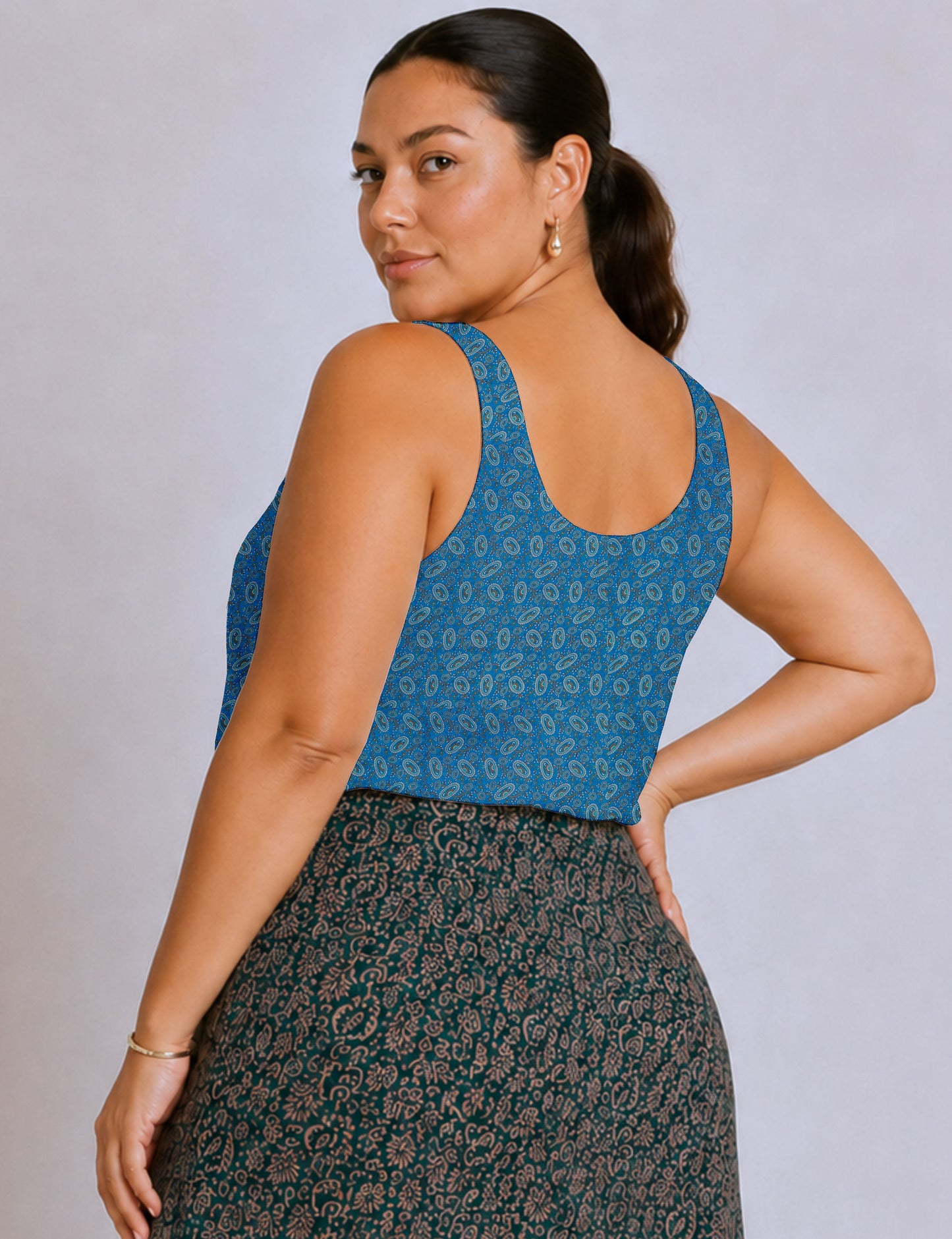 Women's sleeveless blouse with a relaxed straight fit, wide scoop neckline, deep scoop back, and hip-length silhouette.