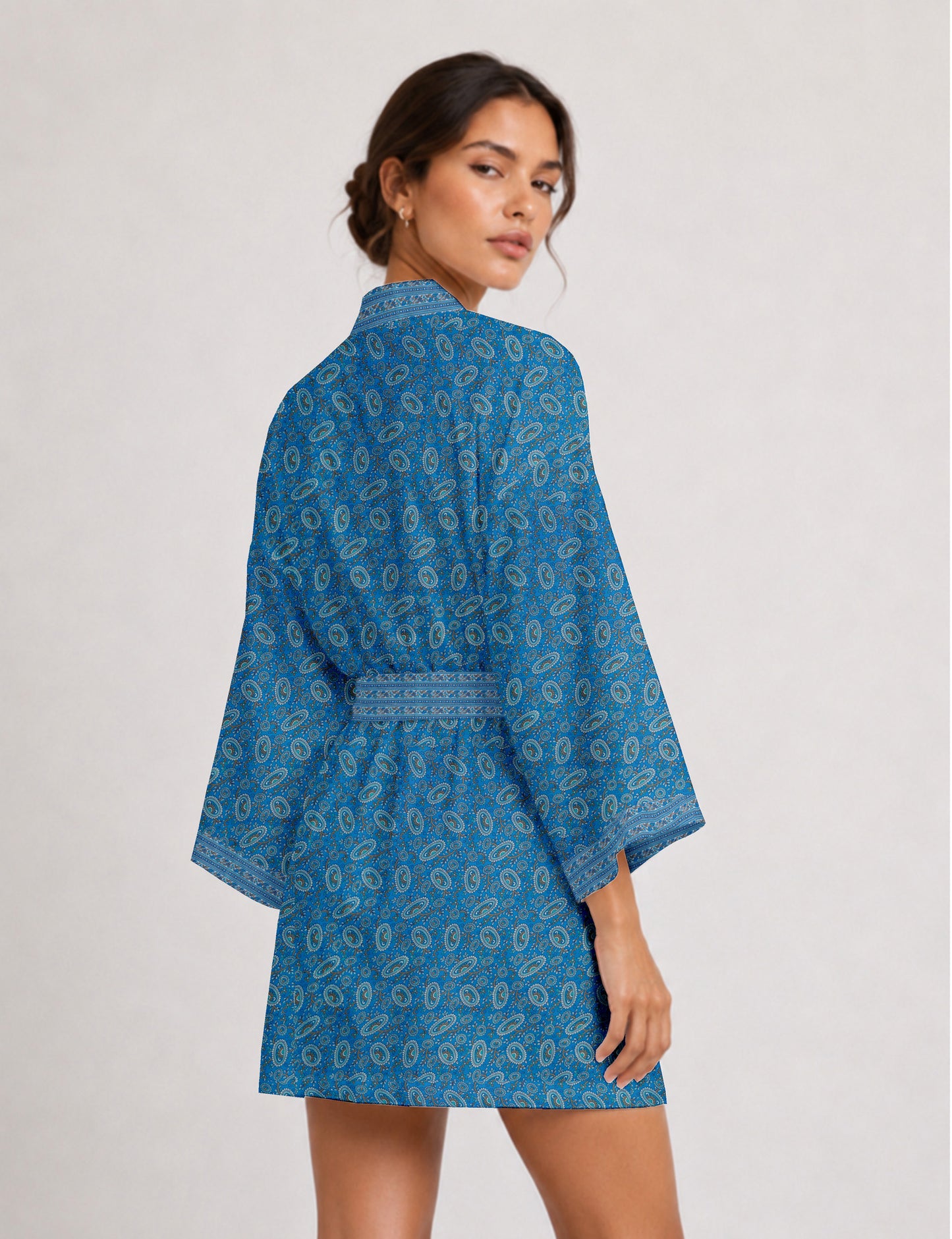 Short kimono robe with wrap front, V-neckline, wide sleeves, waist tie, and concealed skort detail.
