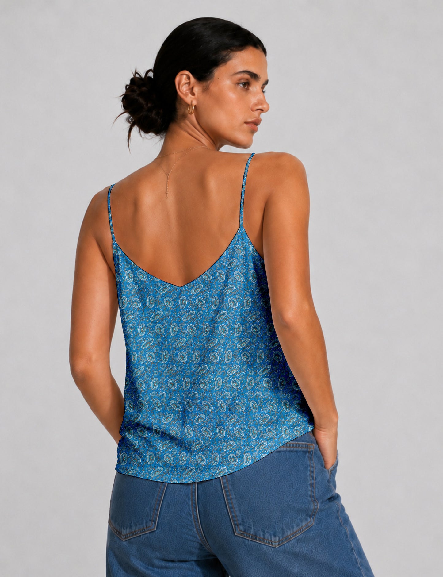 Women's sleeveless slip top with a relaxed straight fit, soft V-neckline, deep V-back, and delicate spaghetti straps.