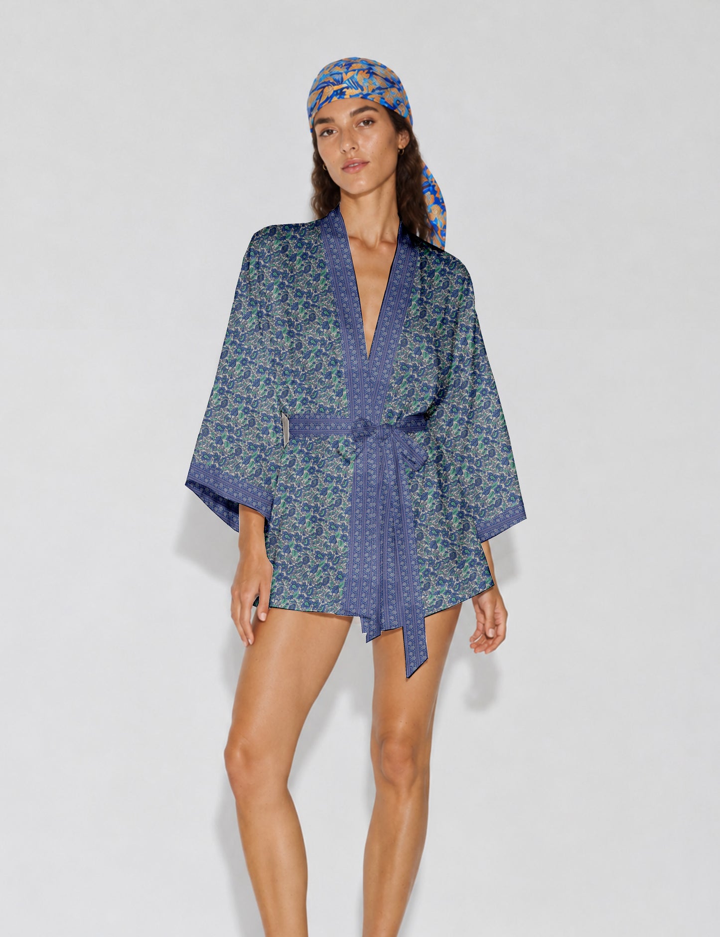 Short kimono robe with wrap front, V-neckline, wide sleeves, waist tie, and concealed skort detail.