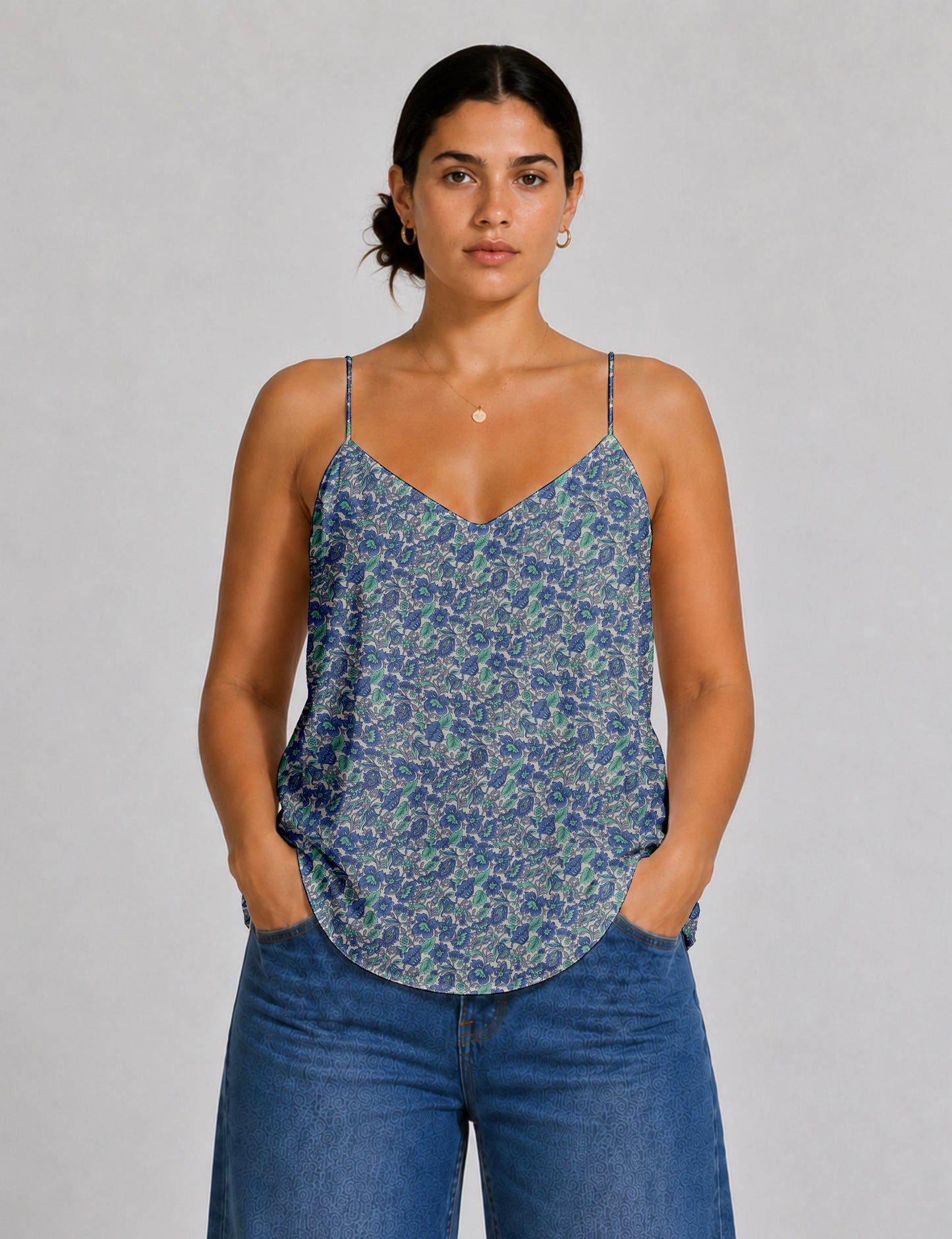 Women's sleeveless slip top with a relaxed straight fit, soft V-neckline, deep V-back, and delicate spaghetti straps.