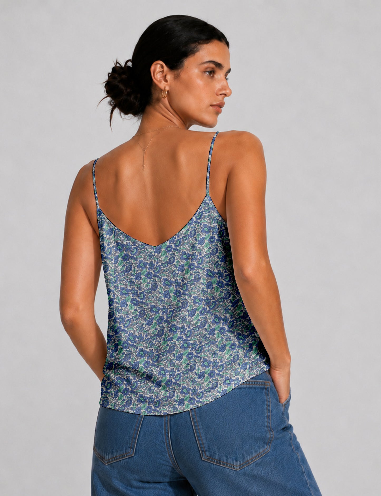 Women's sleeveless slip top with a relaxed straight fit, soft V-neckline, deep V-back, and delicate spaghetti straps.