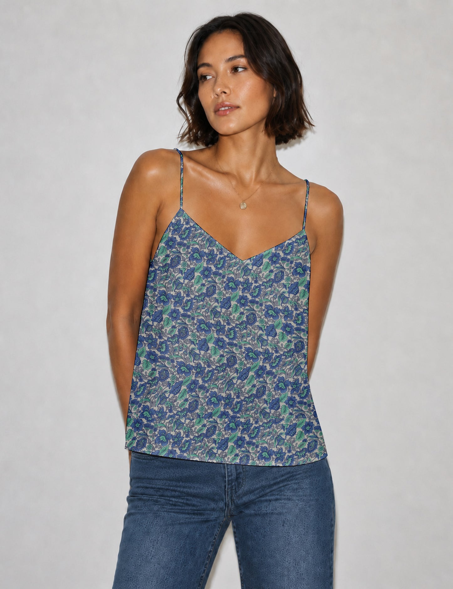 Women's sleeveless slip top with a relaxed straight fit, soft V-neckline, deep V-back, and delicate spaghetti straps.