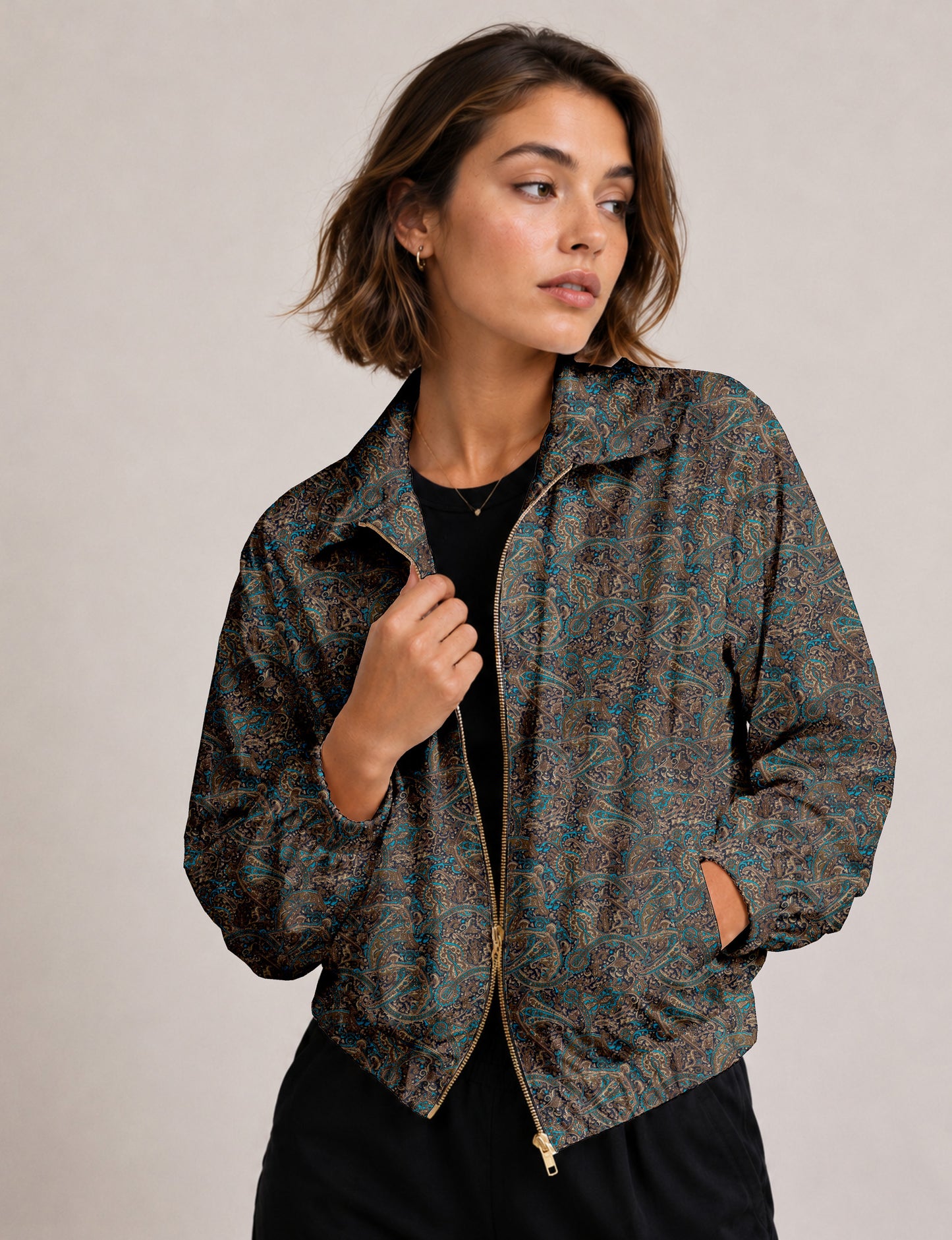 Brown floral bomber jacket with front zipper, elastic cuffs and hem, hanging on white hanger, red floral inner lining visible