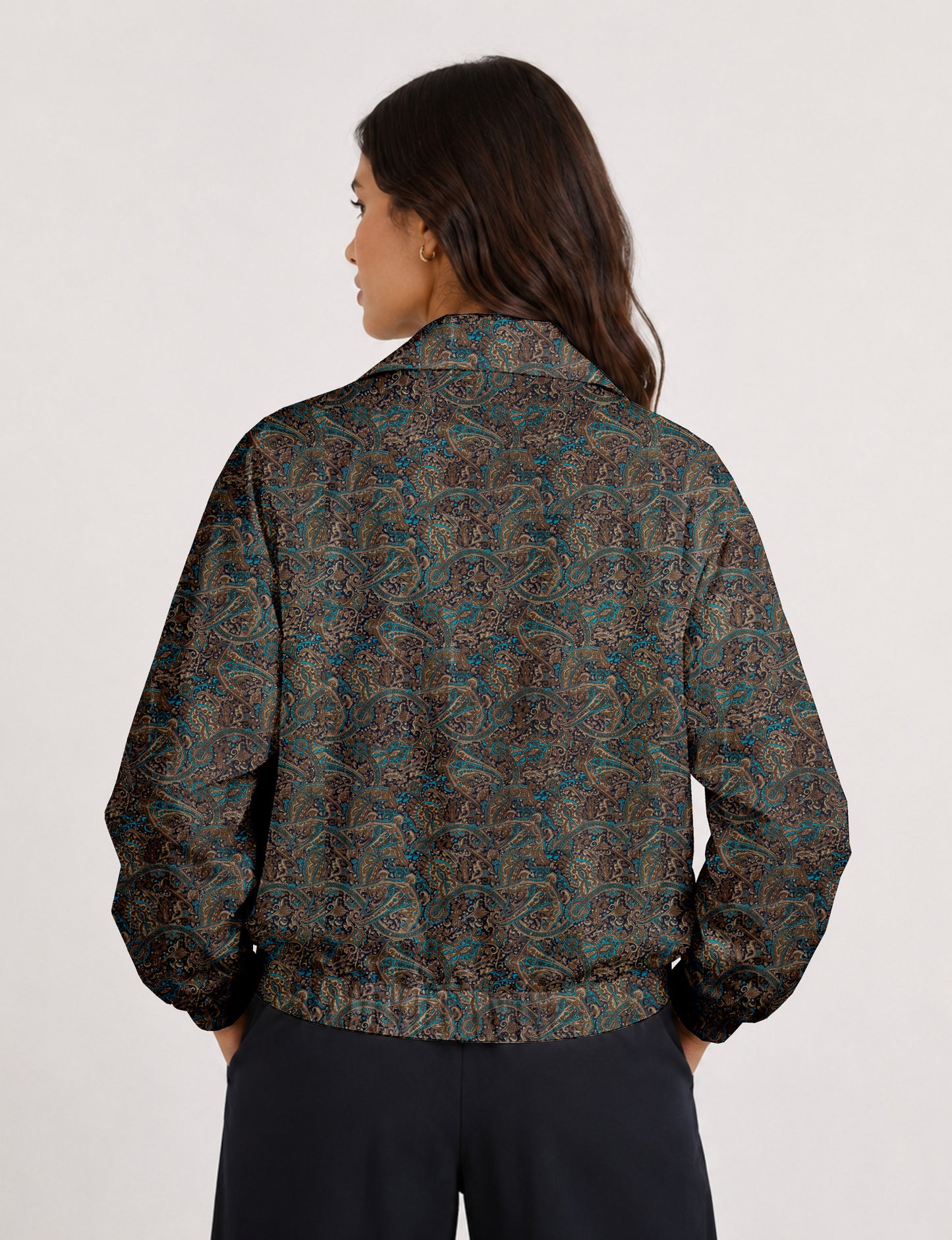 Woman wearing a yellow floral bomber jacket with front zipper, elastic cuffs, and side pockets, shown from front view
