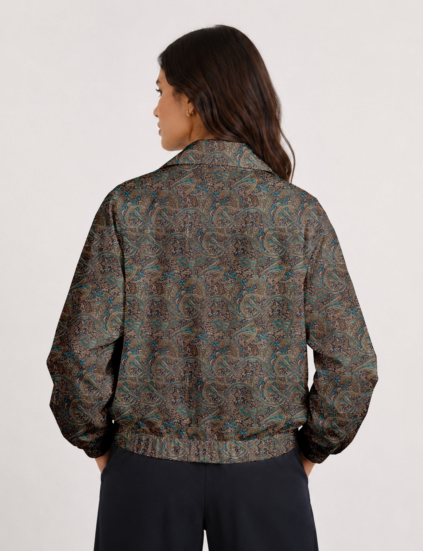 Woman wearing a yellow floral bomber jacket with front zipper, elastic cuffs, and side pockets, shown from front view