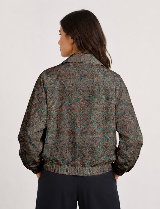 Woman wearing a yellow floral bomber jacket with front zipper, elastic cuffs, and side pockets, shown from front view