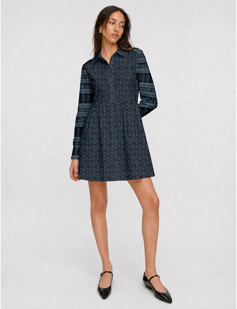 Short shirt dress with a relaxed A-line silhouette, point collar, partial button placket, gathered waist, side pockets, and full-length cuffed sleeves.