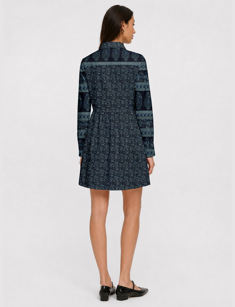 Short shirt dress with a relaxed A-line silhouette, point collar, partial button placket, gathered waist, side pockets, and full-length cuffed sleeves.