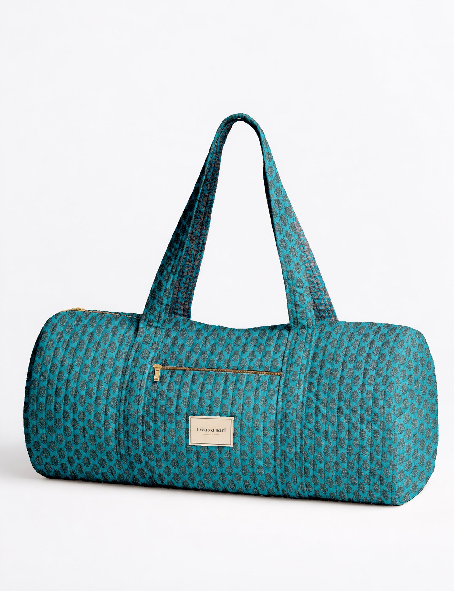 Brown paisley quilted bowling bag with dual handles, front zipper pocket, and "I was a sari" label on front side