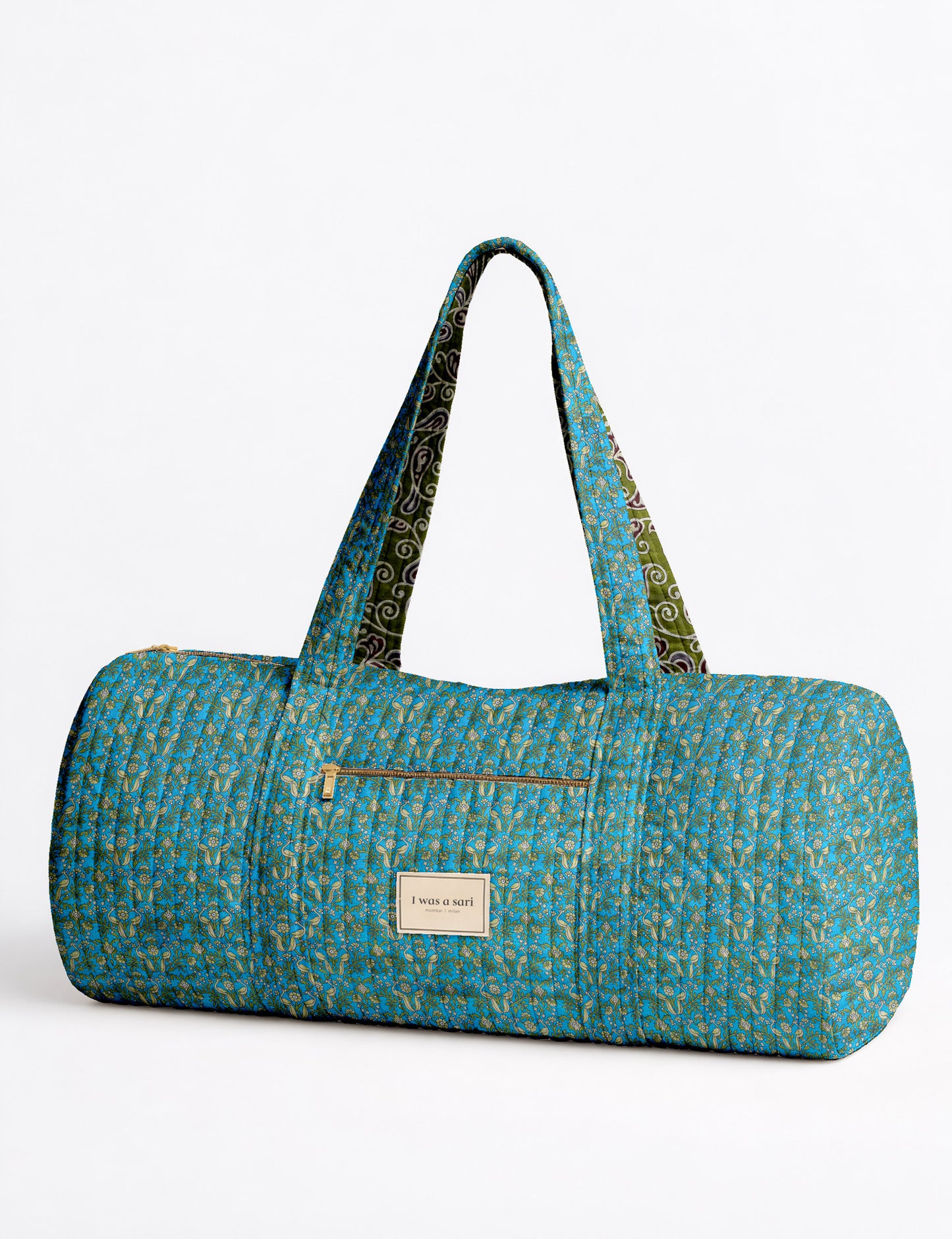 Brown paisley quilted bowling bag with dual handles, front zipper pocket, and "I was a sari" label on front side