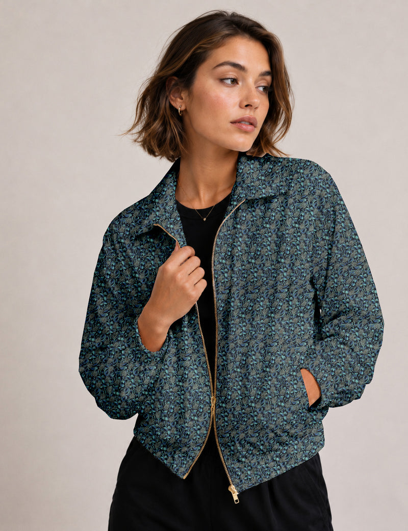 Brown floral bomber jacket with front zipper, elastic cuffs and hem, hanging on white hanger, red floral inner lining visible