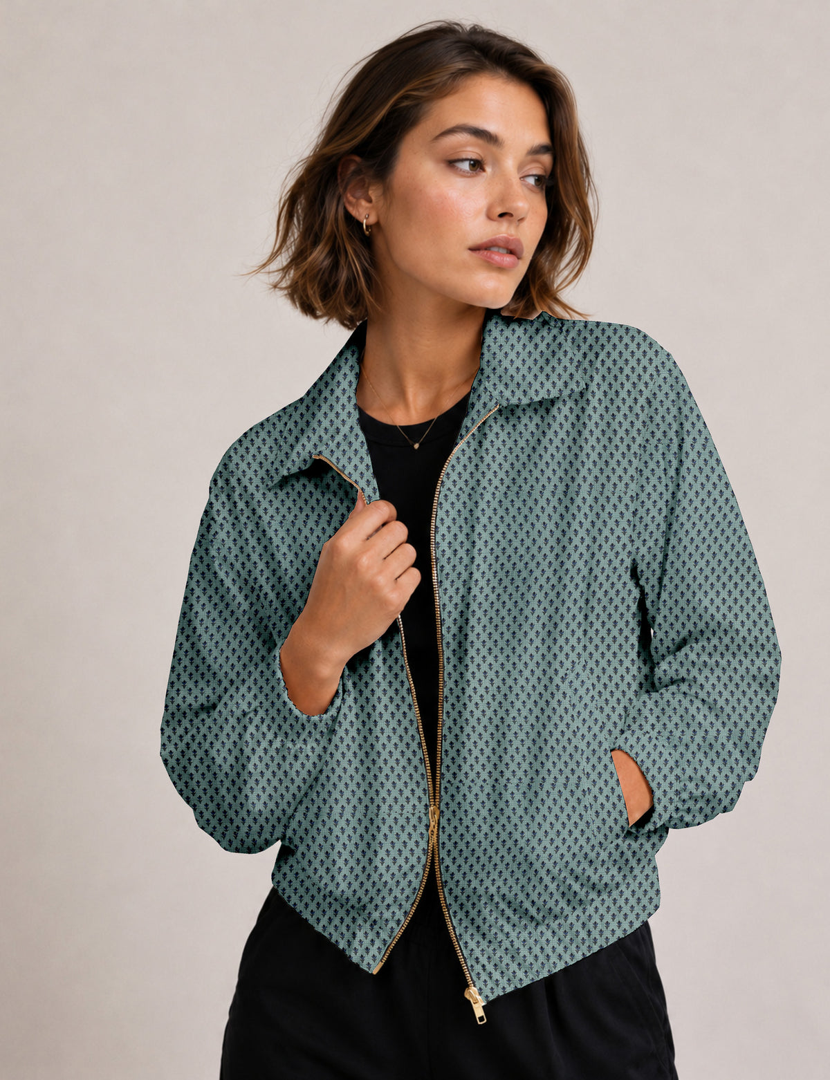 Woman wearing a yellow floral bomber jacket with front zipper, elastic cuffs, and side pockets, shown from front view
