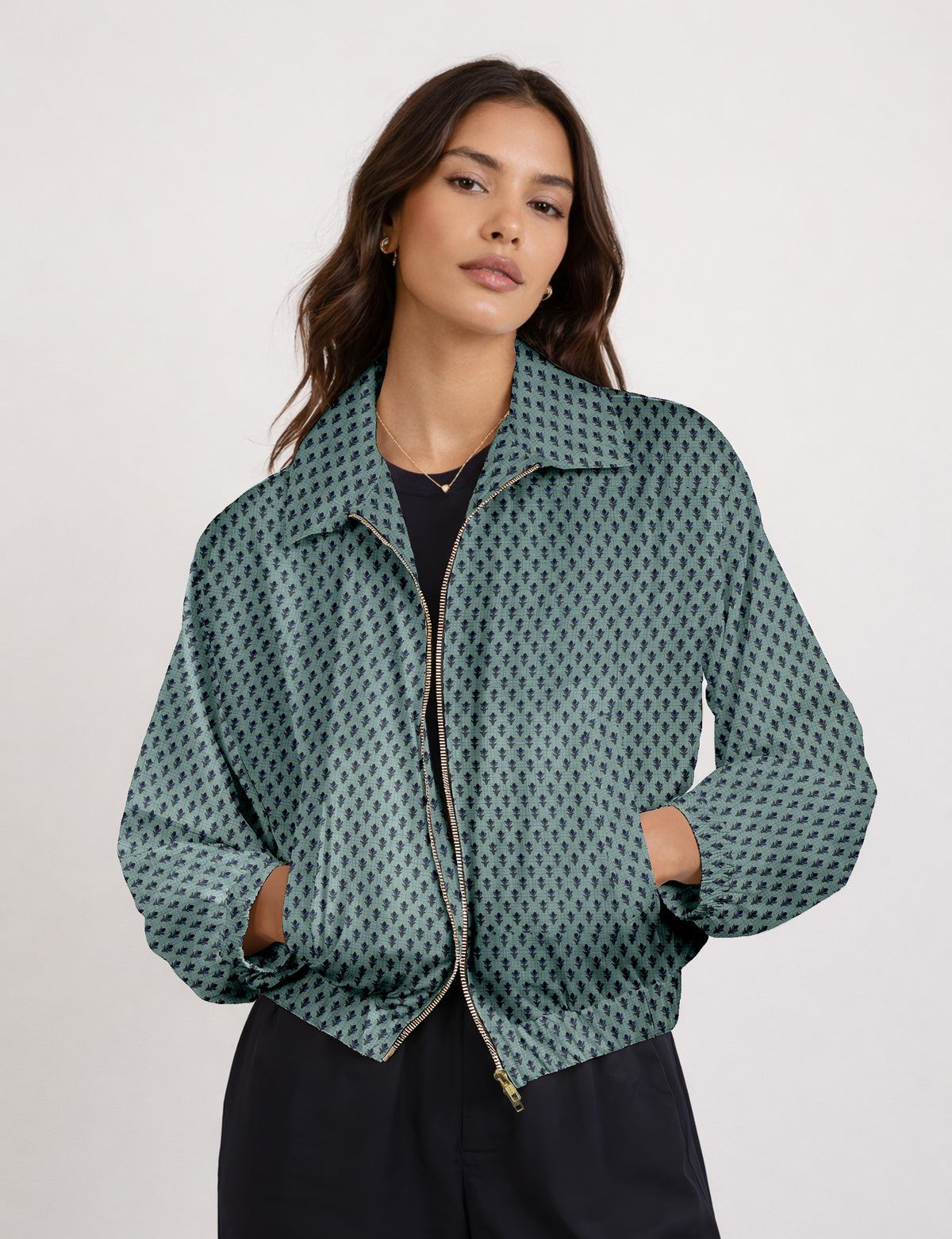 Brown floral bomber jacket with front zipper, elastic cuffs and hem, hanging on white hanger, red floral inner lining visible
